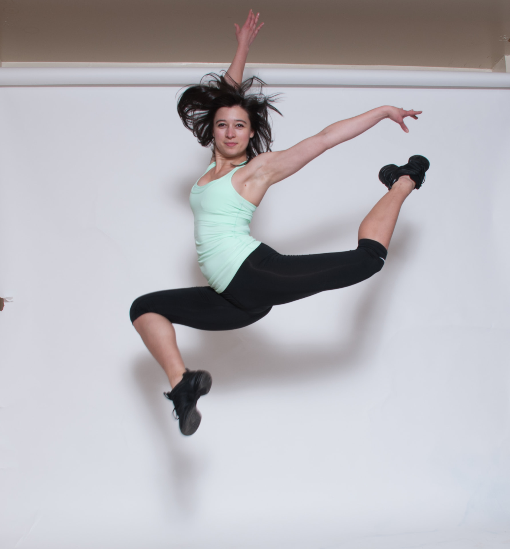 Nadya mid-air in an athletic leap
